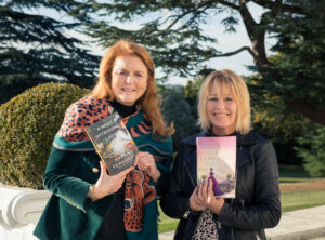 Sarah Ferguson, Duchess of York, and Marguerite Kaye pose with copies of A Most Intriguing Lady